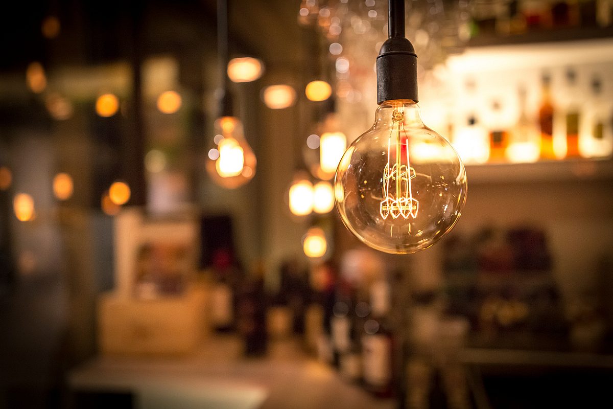 Vintage lamp bulb with blurred bar or cafe night abstract background