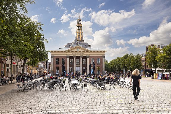 Groningen, The Netherlands, August 4, 2021; Grain exchange building and church tower on the fish market square in the student city of Groningen.
