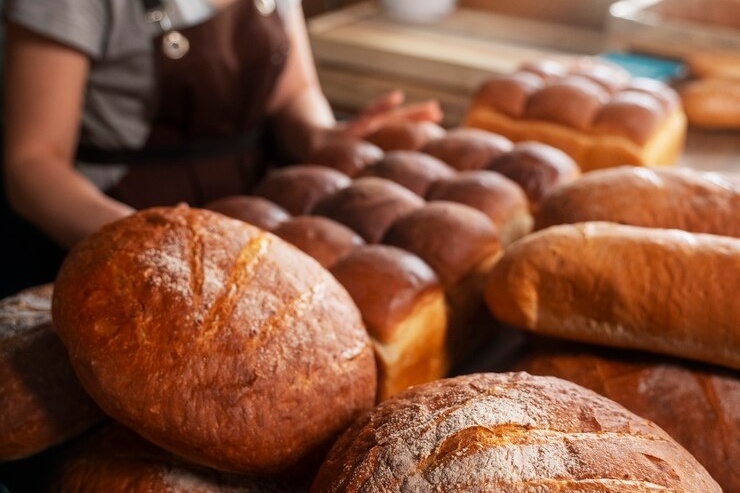Female baker with baked bread pastry shop 23 2150379590 Cropped