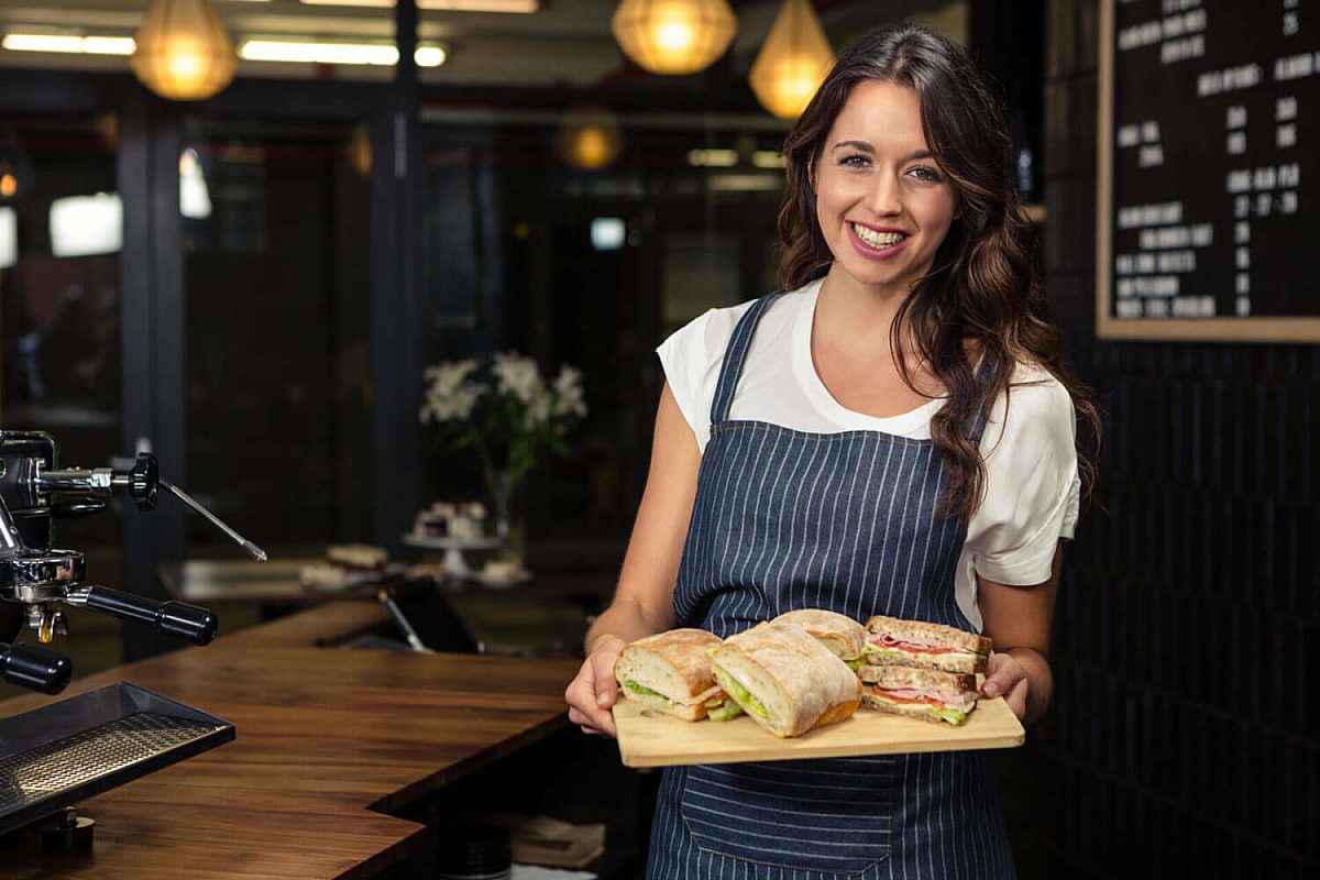 Horecamedewerker serveert broodjeslunch